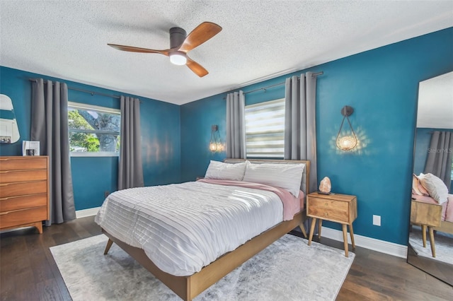 bedroom featuring a textured ceiling, ceiling fan, and dark hardwood / wood-style floors