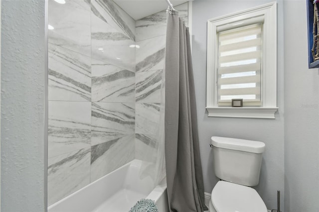 bathroom featuring toilet and shower / bath combo with shower curtain