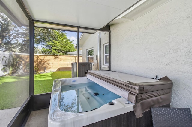 sunroom / solarium with a hot tub