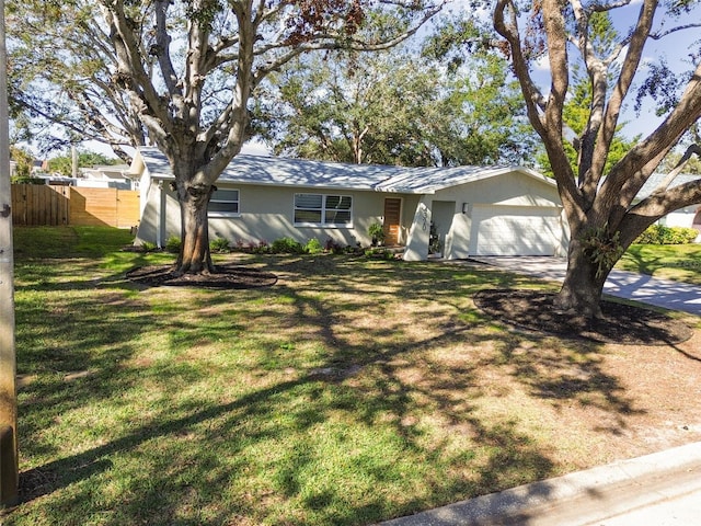 ranch-style house featuring a front lawn and a garage