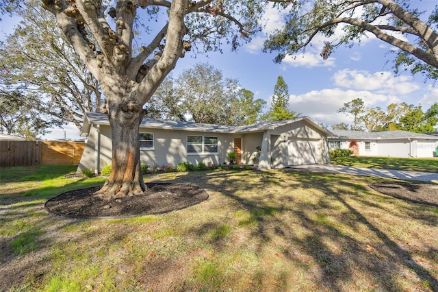 ranch-style house featuring a garage and a front lawn