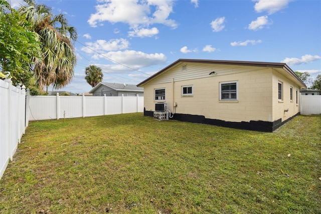 rear view of property featuring a lawn