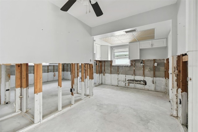 interior space with ceiling fan and white cabinets