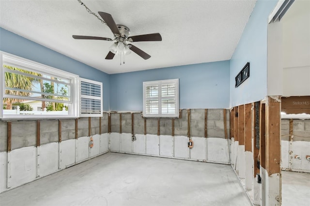 interior space featuring ceiling fan and a textured ceiling