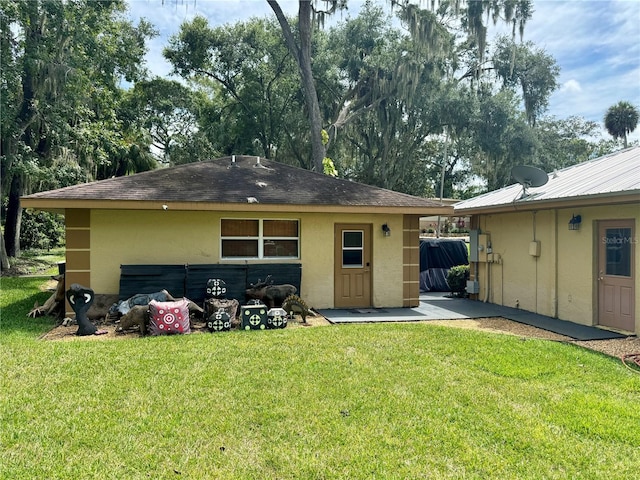 rear view of house with a lawn