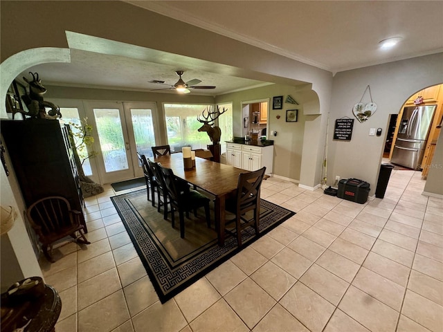 dining area featuring ceiling fan, light tile patterned floors, and crown molding