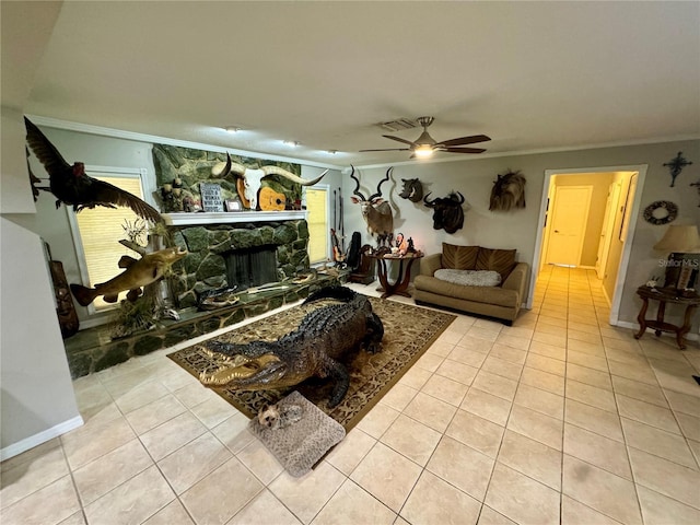 tiled living room with ceiling fan and crown molding