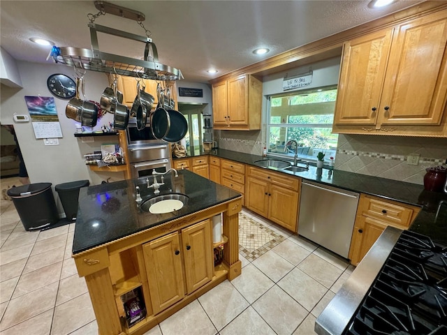 kitchen featuring light tile patterned floors, stainless steel appliances, and sink