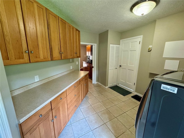 kitchen featuring light tile patterned floors and a textured ceiling