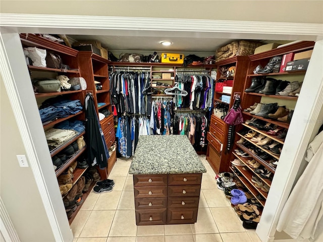 walk in closet with light tile patterned floors