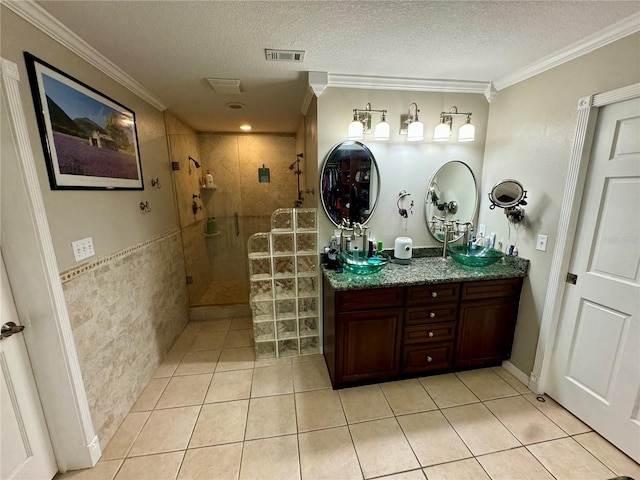 bathroom featuring tile patterned flooring, vanity, a shower with shower door, and ornamental molding