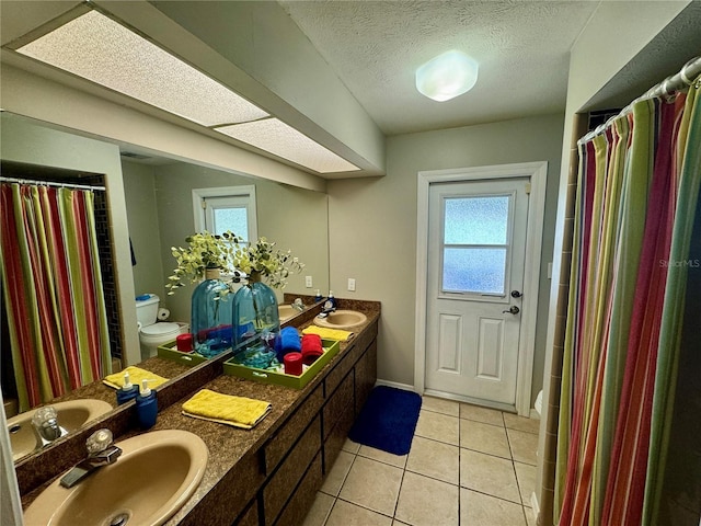 bathroom featuring tile patterned floors, vanity, and toilet