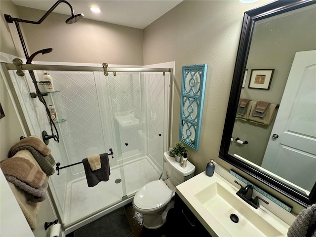 bathroom featuring vanity, toilet, and an enclosed shower