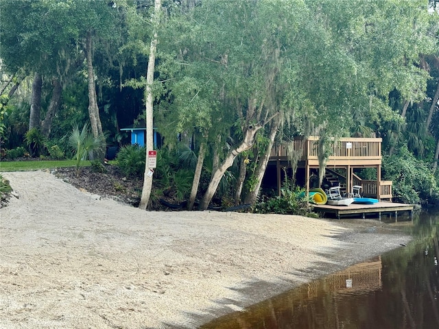 exterior space featuring a deck with water view