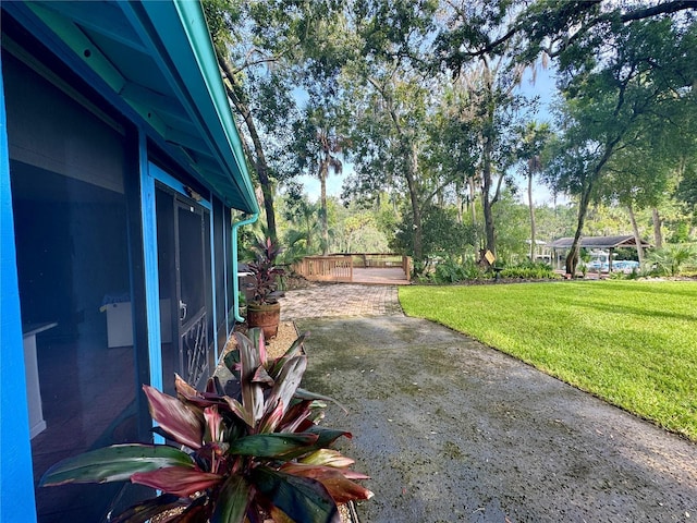 view of yard with a patio area and a wooden deck