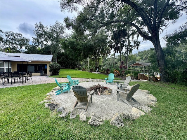 view of yard with a gazebo, a patio area, and an outdoor fire pit