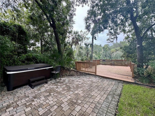 view of patio featuring a wooden deck and a hot tub