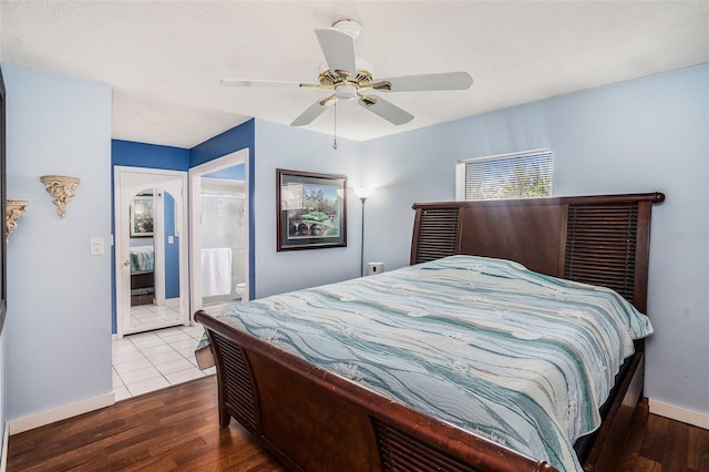 bedroom featuring ensuite bath, ceiling fan, and wood-type flooring