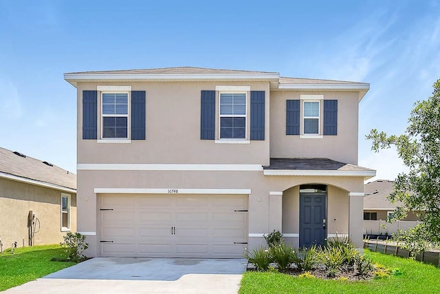 view of front facade featuring a front yard and a garage