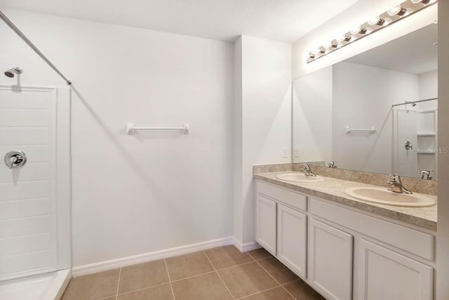 bathroom featuring tile patterned floors, a shower, and vanity