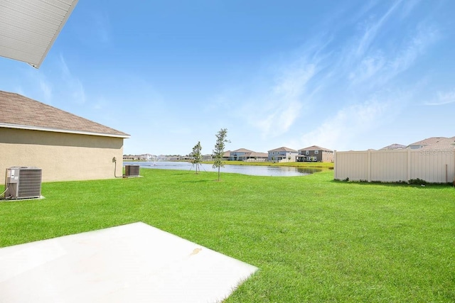 view of yard featuring cooling unit, a water view, and a patio area