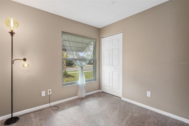 unfurnished room featuring carpet flooring