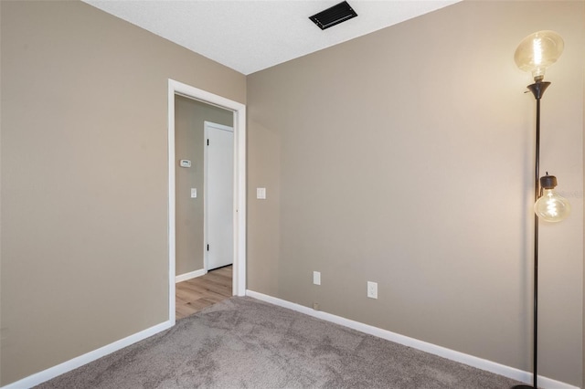 unfurnished room featuring light colored carpet