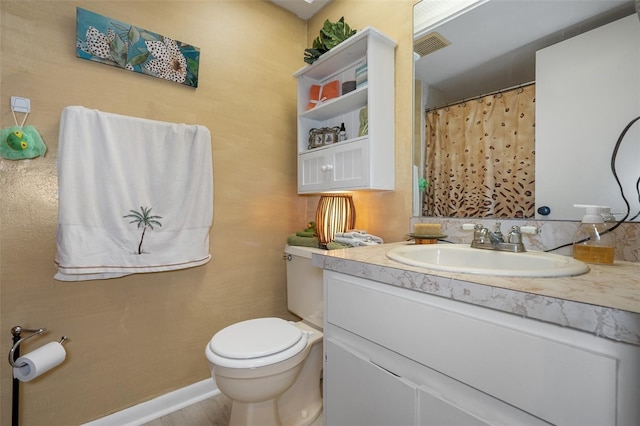 bathroom featuring vanity and toilet