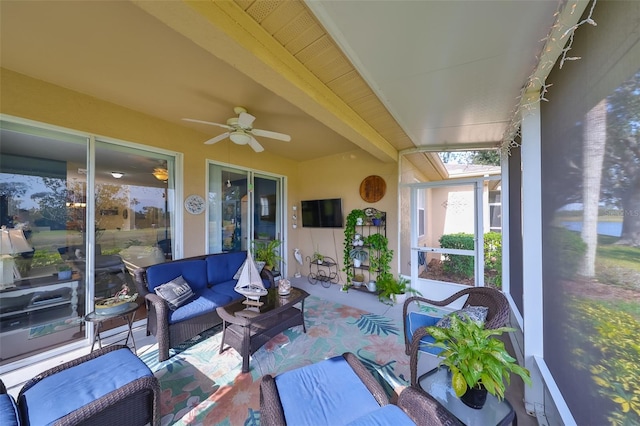 sunroom / solarium featuring ceiling fan