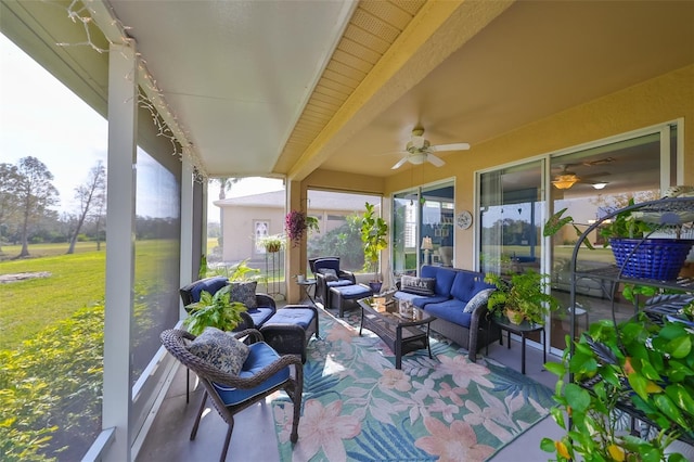 sunroom with beam ceiling and ceiling fan