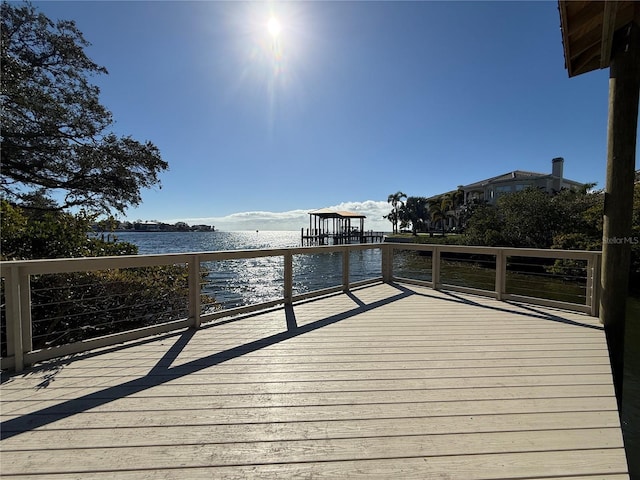 wooden terrace featuring a water view