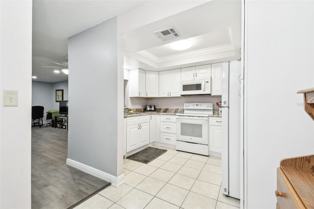 kitchen featuring white appliances, ceiling fan, crown molding, light tile patterned floors, and white cabinets