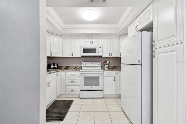 kitchen featuring white cabinets, light tile patterned flooring, a raised ceiling, and white appliances