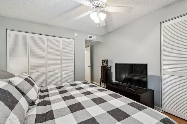 bedroom with ceiling fan and a textured ceiling