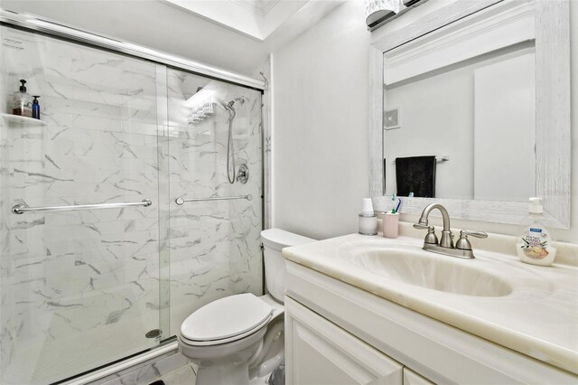 bathroom featuring vanity, toilet, and an enclosed shower