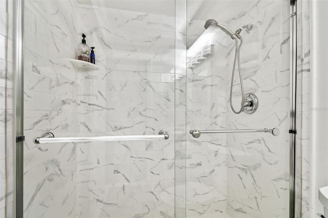 bathroom with a shower with shower door