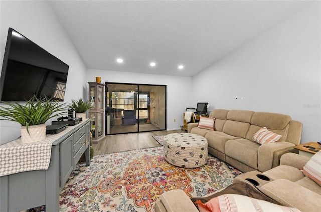 living room featuring a textured ceiling and light hardwood / wood-style floors