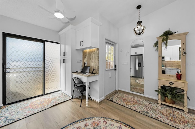 entrance foyer with ceiling fan and light wood-type flooring