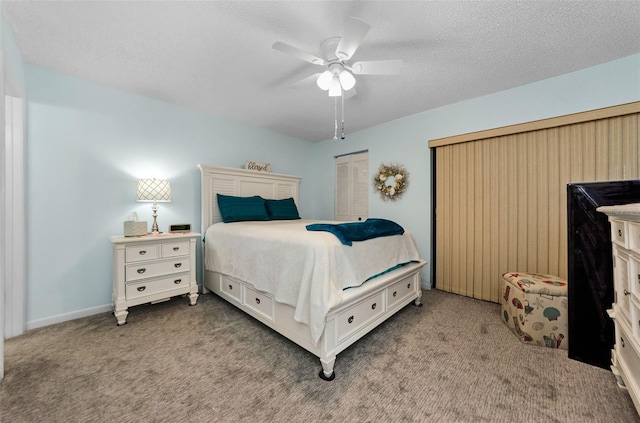 carpeted bedroom featuring ceiling fan, a closet, and a textured ceiling