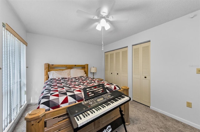 bedroom with carpet, two closets, and ceiling fan