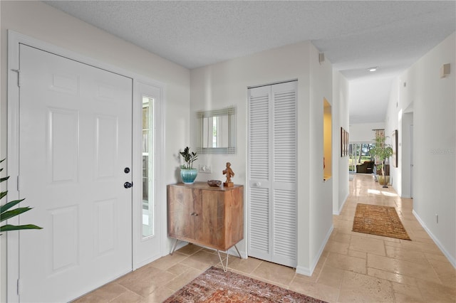 entryway with a textured ceiling