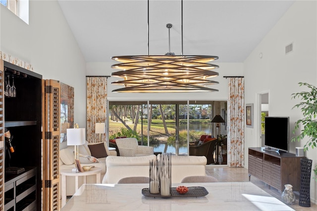 interior space with a chandelier and high vaulted ceiling