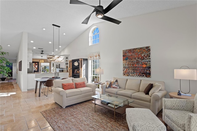 living room featuring a textured ceiling, high vaulted ceiling, and ceiling fan