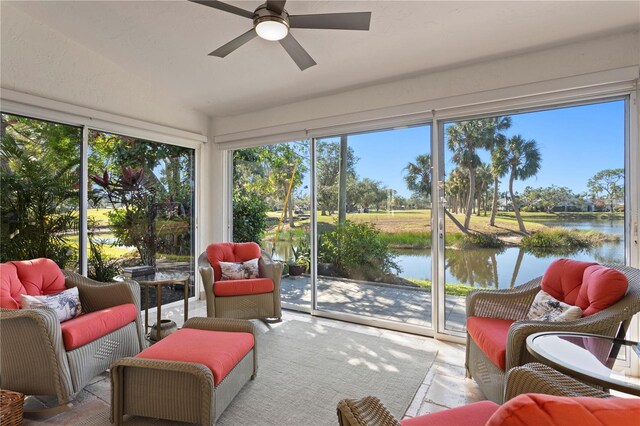 sunroom / solarium featuring a water view and ceiling fan