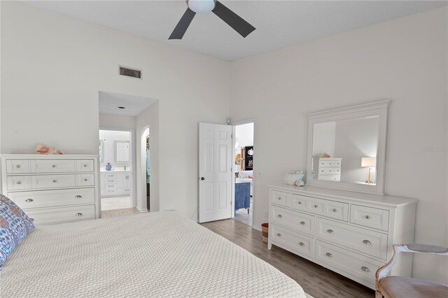 bedroom featuring ensuite bathroom, dark hardwood / wood-style floors, and ceiling fan