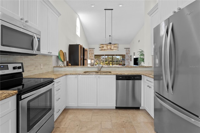 kitchen featuring appliances with stainless steel finishes, decorative light fixtures, sink, white cabinets, and kitchen peninsula