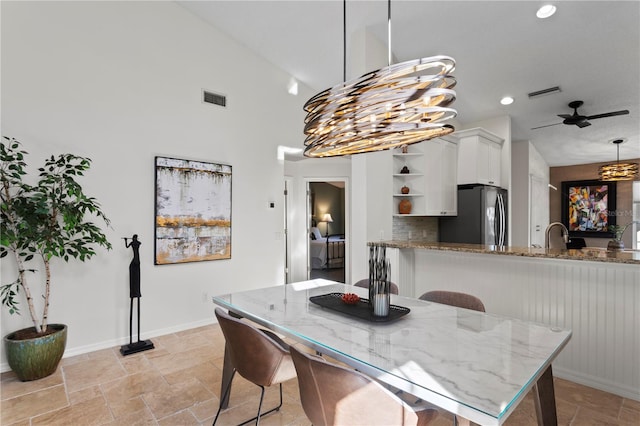 dining area featuring vaulted ceiling and ceiling fan