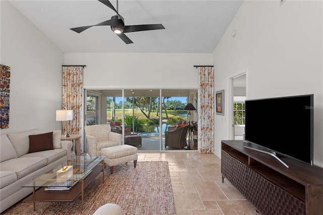 living room featuring a towering ceiling and ceiling fan