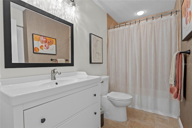 bathroom featuring walk in shower, vanity, toilet, and a textured ceiling