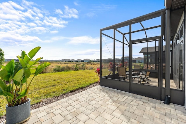 view of patio with glass enclosure